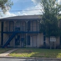 A building with a sign in front of it.