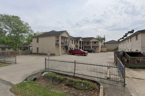 A red car is parked in front of a building.