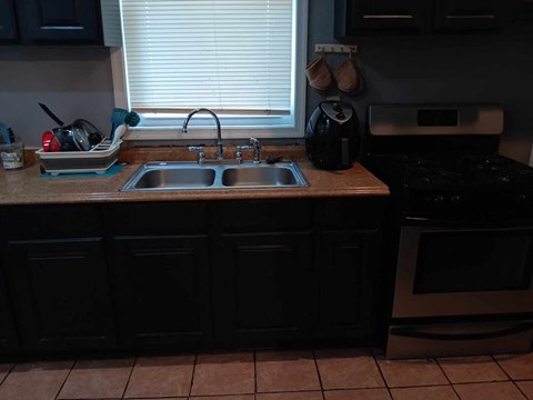 A kitchen with a sink and a stove.