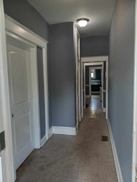 A long hallway with doors on both sides.