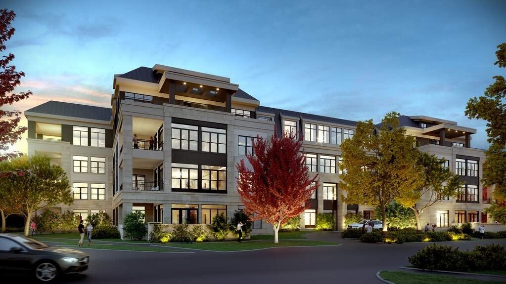 A modern apartment building with a tree in front of it.