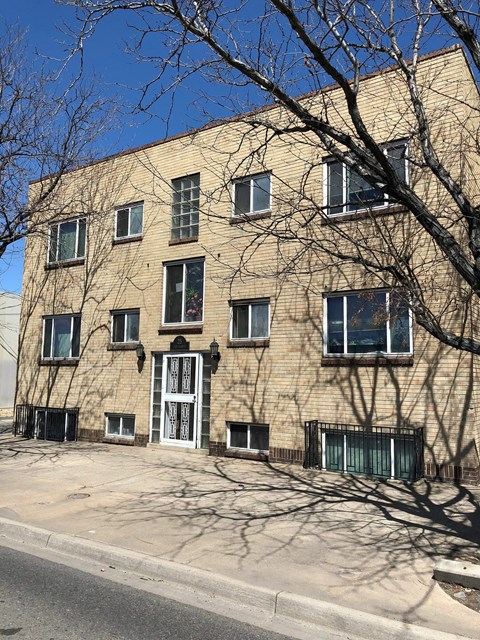 A building with a tree in front of it.