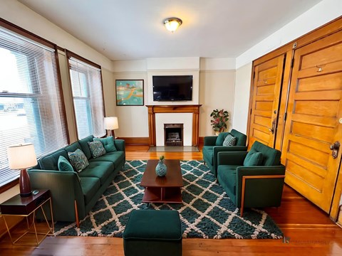 A living room with a fireplace and a television.