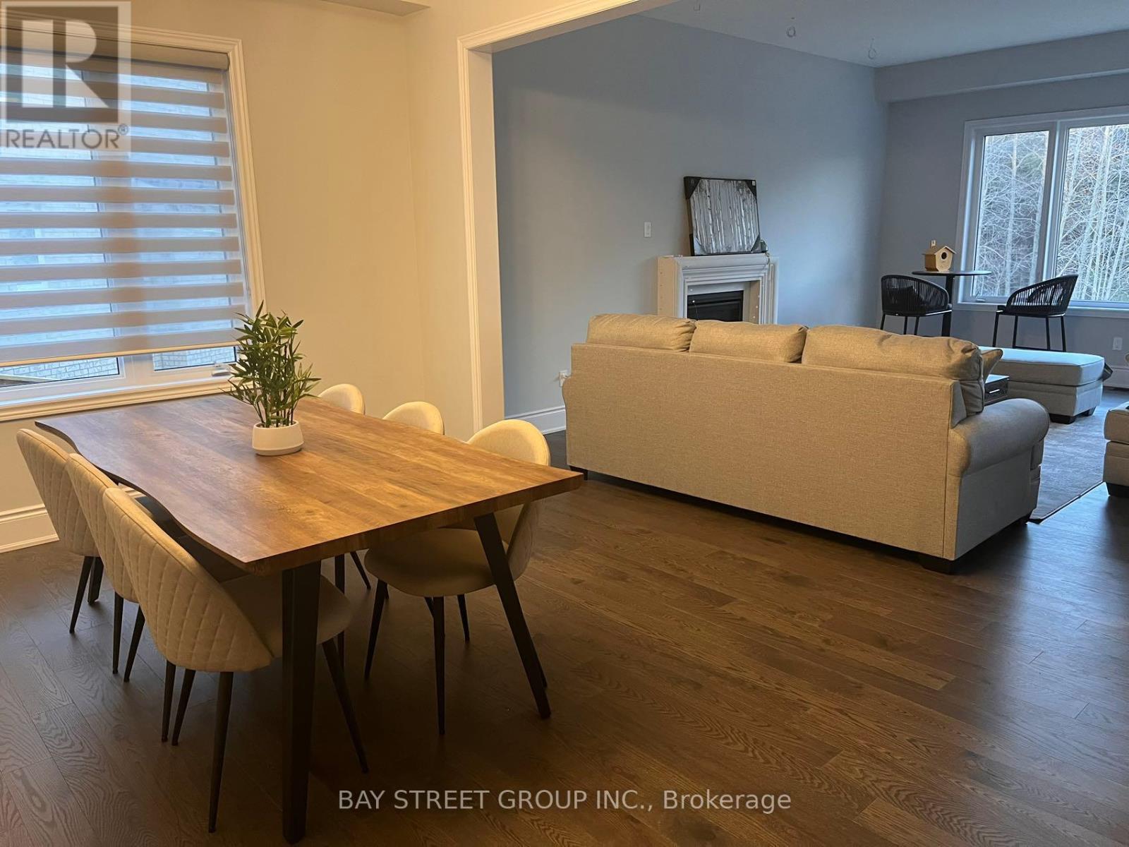 A living room with a couch, chairs, and a table.
