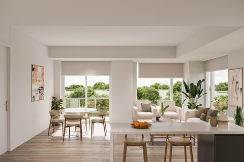 A modern dining room with a table set for two and a view of the backyard.