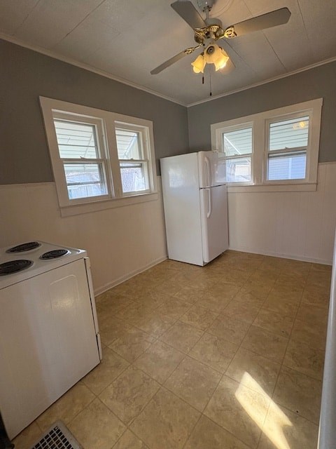 A kitchen with a white refrigerator, a white dishwasher, and a ceiling fan.