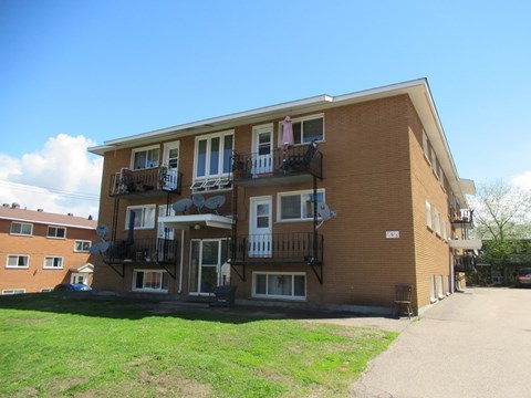 A large brick building with a balcony on the second floor.