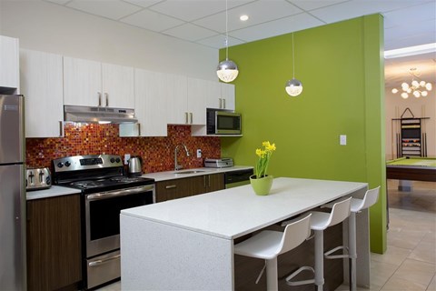 A kitchen with a white table and chairs.
