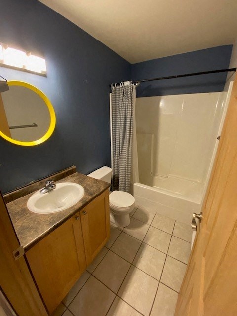 A bathroom with a toilet, sink, and shower.