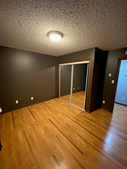 A room with wooden flooring and a ceiling light.