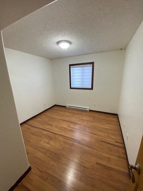 A room with wooden floors and a window.