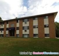 A building with a sign that says "Listed by Renters Warehouse".