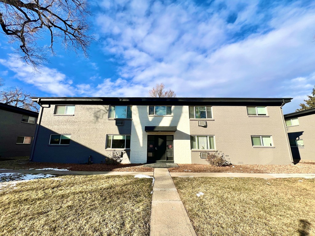 A building with a blue sky and clouds in the background.