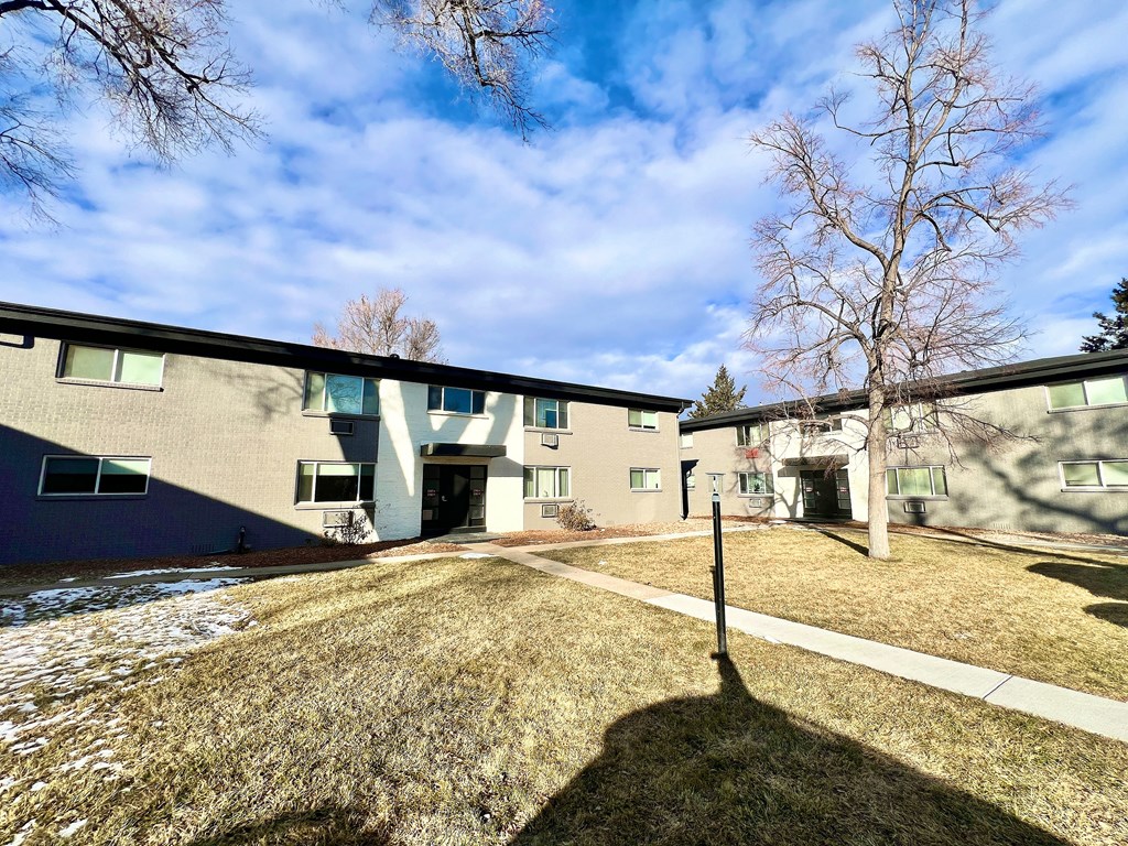 A building with a shadow of a person in front of it.