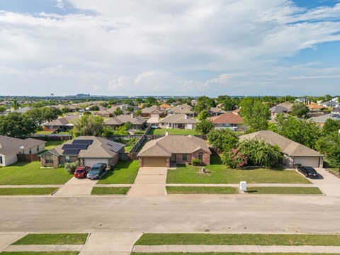 A suburban neighborhood with houses and driveways.