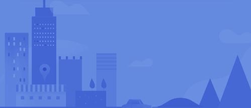 A cityscape with various buildings and a mountain in the background.