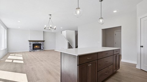 A modern kitchen with dark wood cabinets and a white island.