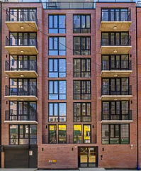 A red brick building with balconies on the second floor.