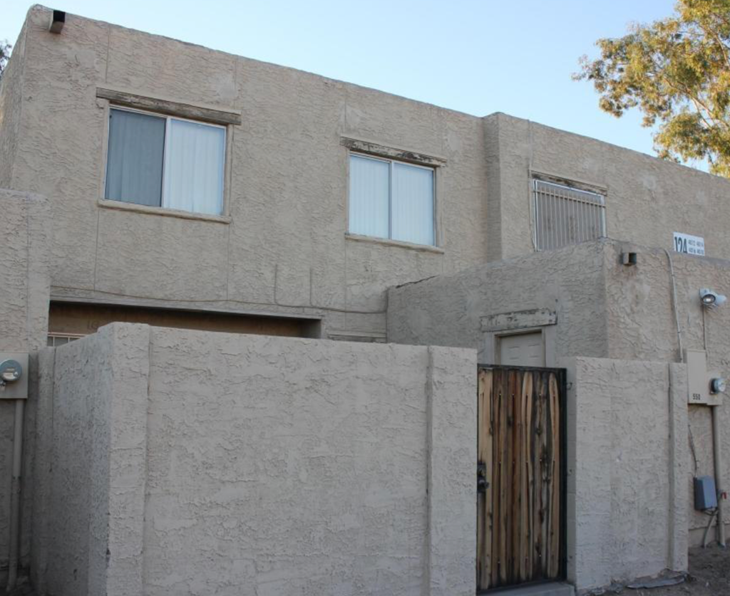 A building with a wooden door and windows.