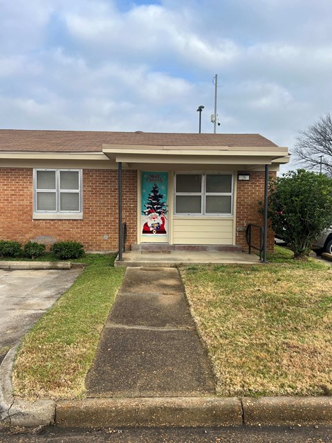A house with a Christmas tree on the front door.