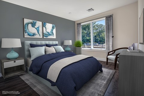 A bedroom with a large bed and a painting on the wall.