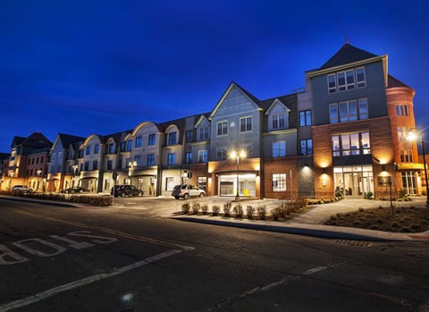 A row of houses are lit up at night.