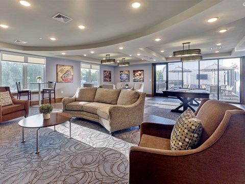 A living room with a brown couch and a coffee table.
