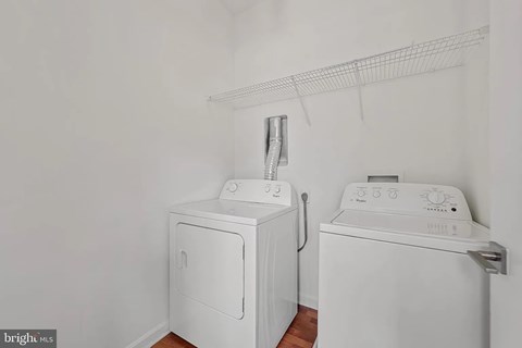 A white dryer and washer in a laundry room.