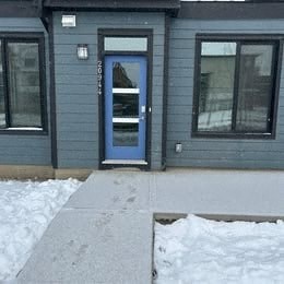 A small house with a blue door and windows.