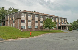 A building with a parking lot in front of it.