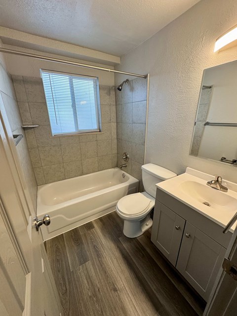 A white toilet sits next to a sink in a bathroom.
