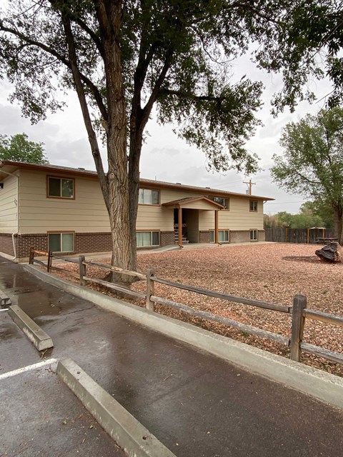 A house with a brown roof and a brown fence.