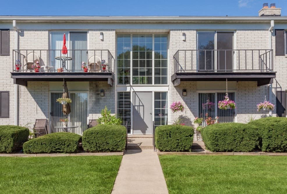 A building with a balcony and a glass door.