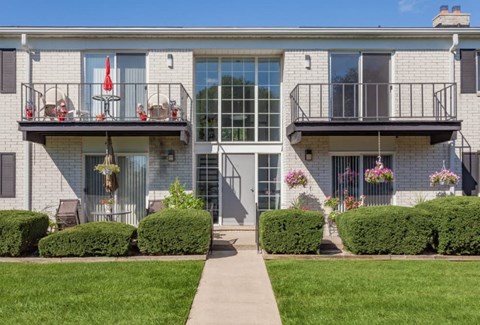 A building with a balcony and a glass door.