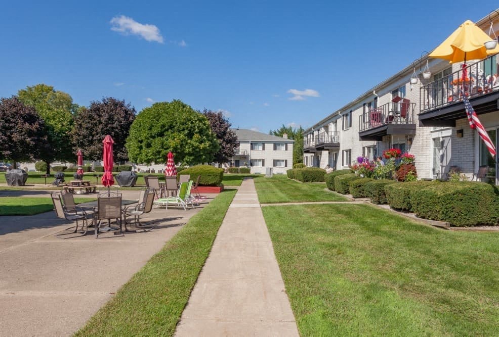 A sunny day at a park with tables and chairs set up for outdoor dining.