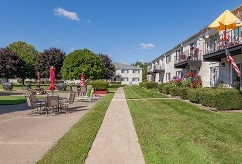 A sunny day at a park with tables and chairs set up for outdoor dining.