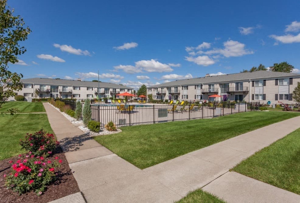 A sunny day at a residential complex with a clear blue sky.