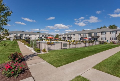 A sunny day at a residential complex with a clear blue sky.