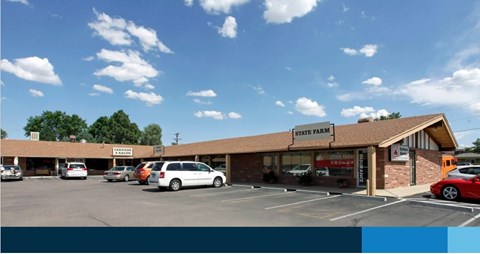 A State Farm office with a parking lot in front.