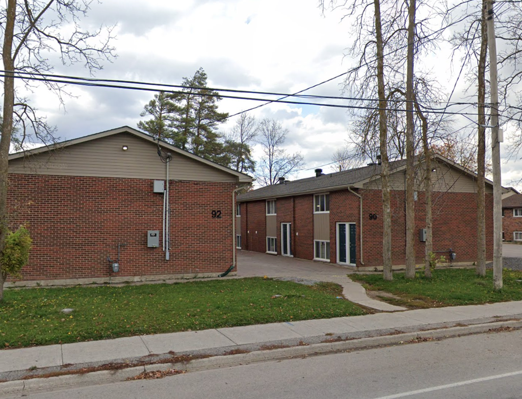 A brick building with the number 92 on it.