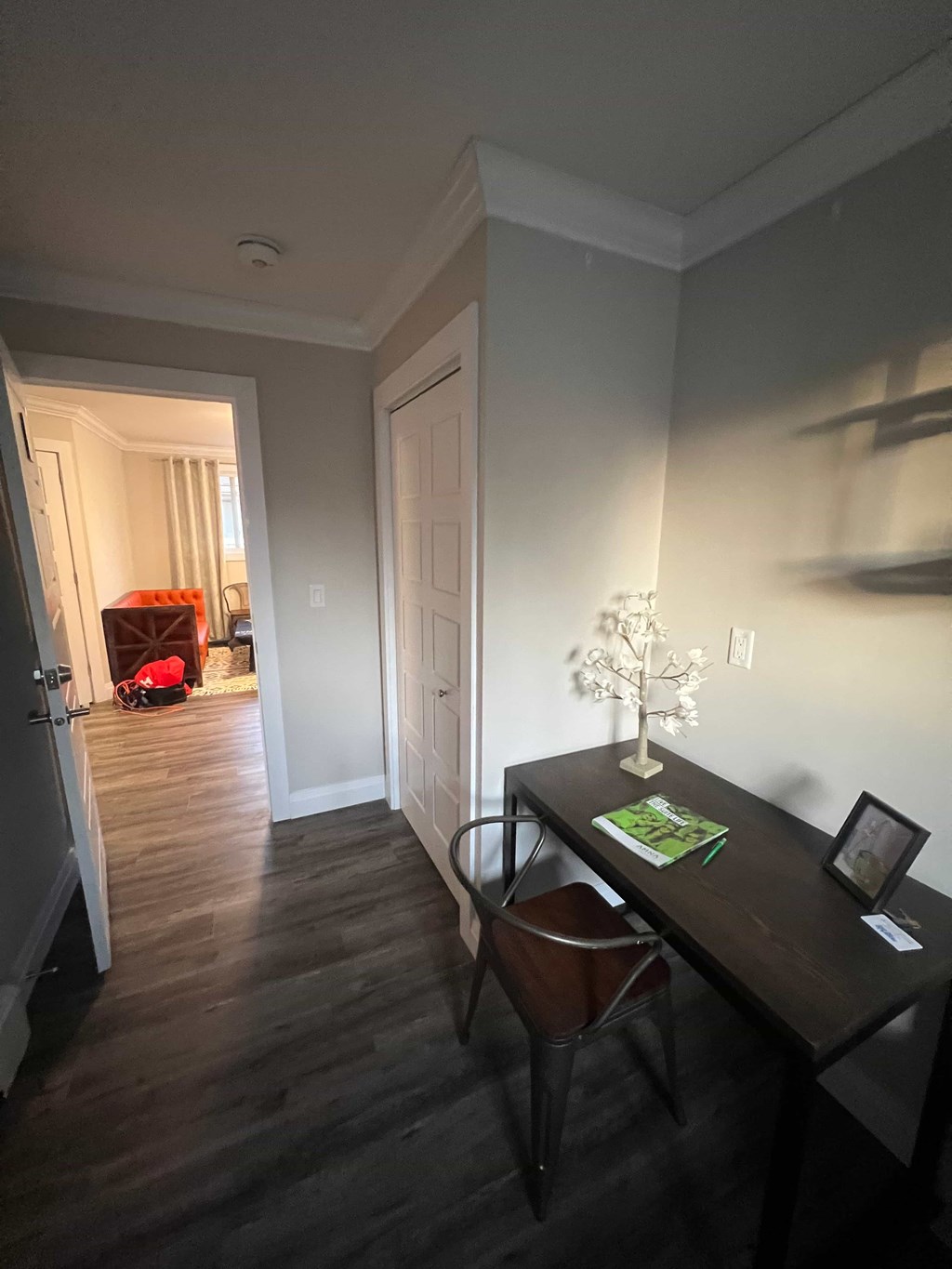 A room with a desk and chair in it.