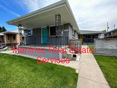 A house with a sign that says Martinez Real Estate Services.