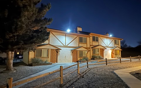 A house with lights on at night.