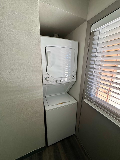 A white washing machine is in a small room.