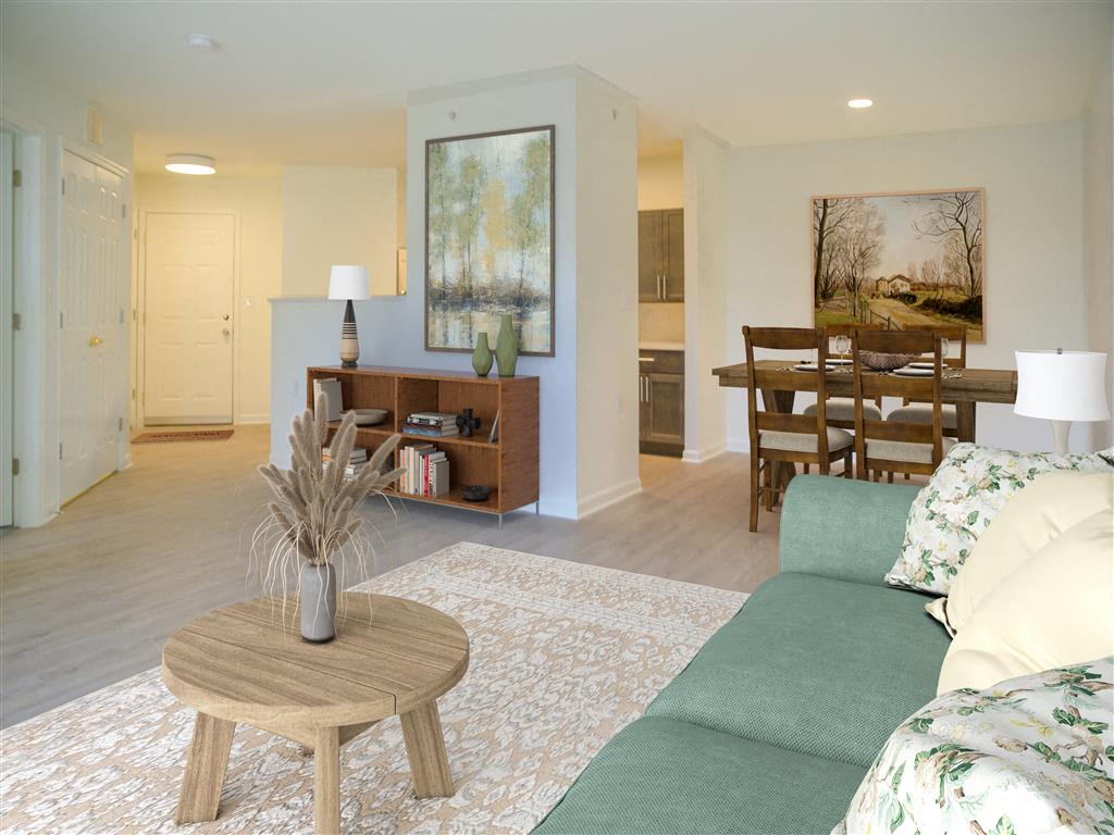 A living room with a couch, a coffee table, and a painting on the wall.