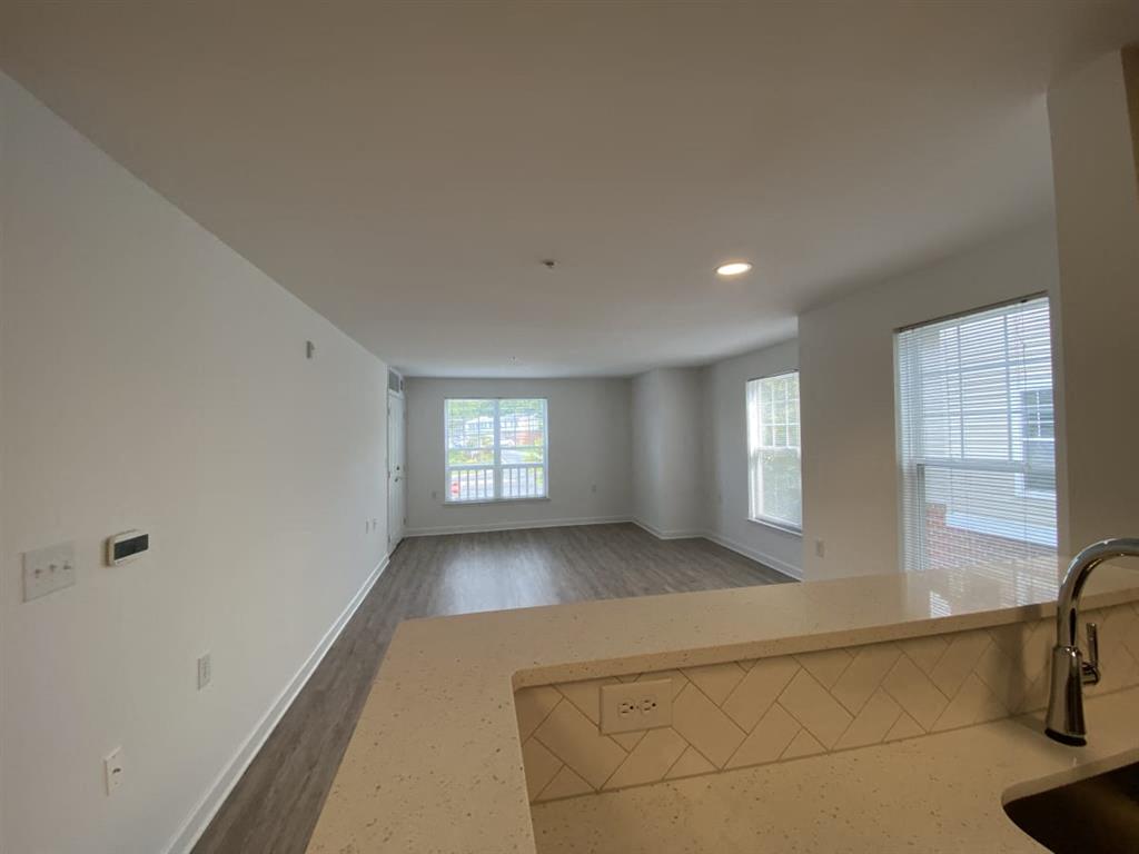 A kitchen area with a sink and a window.