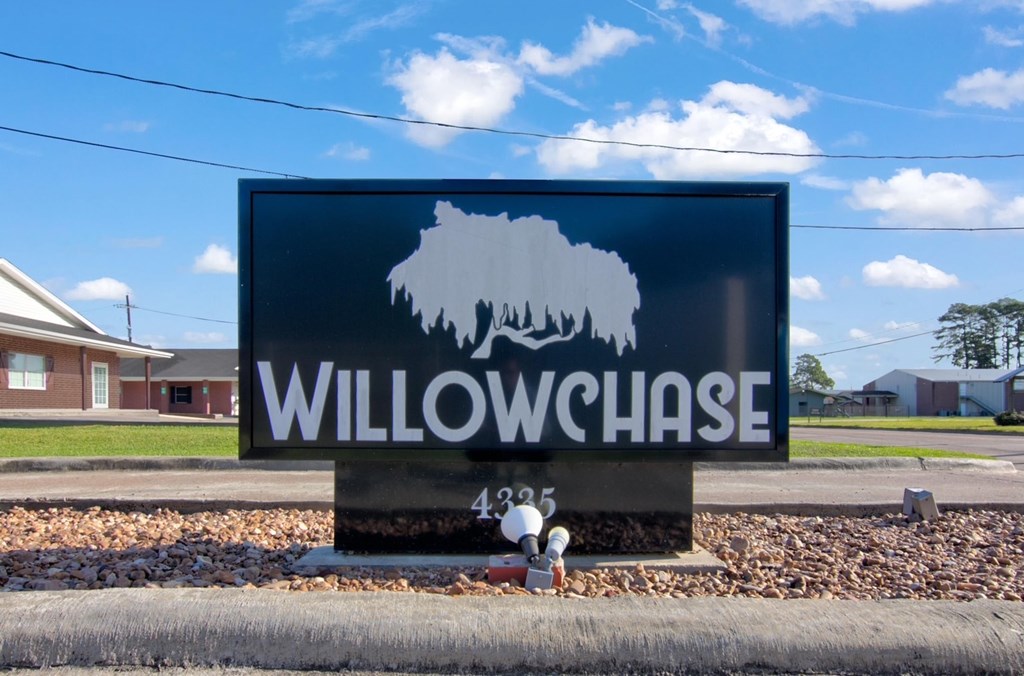 A sign for Willowchase with a tree silhouette on it.