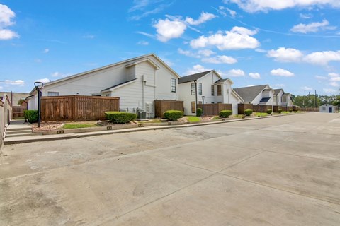 A row of houses with a clear blue sky above them.