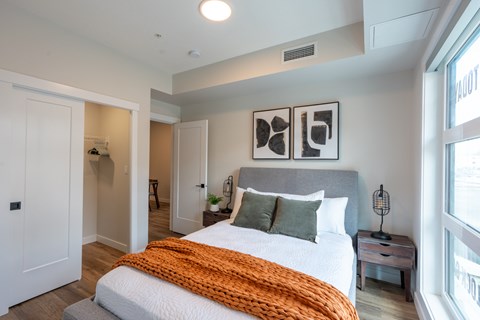 A bedroom with a large bed and a window.