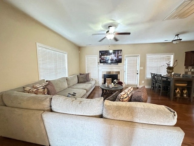 A living room with a large couch and a flat screen TV mounted on the wall.